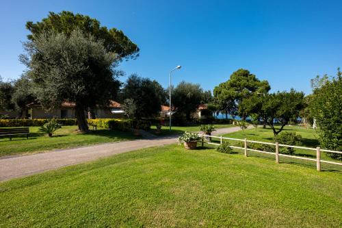 a park with a fence and green grass and trees at Sopramare Resort in Piano di Sorrento