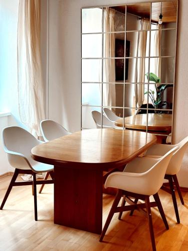 a dining room with a wooden table and chairs at Wohnung in Graz - city center in Graz