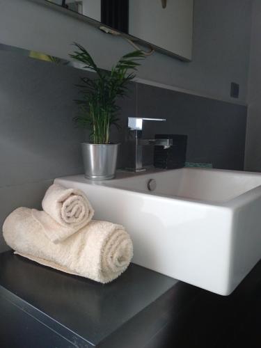 a white sink in a bathroom with towels at Alloggio Turistico in Viterbo