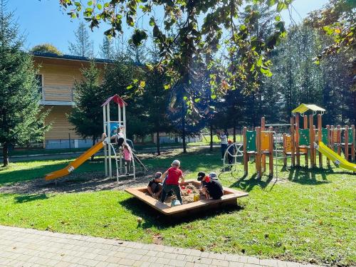 a group of children playing in a playground at Ośrodek Wczasów Zdrowotnych Rudawka Rymanowska in Rudawka Rymanowska