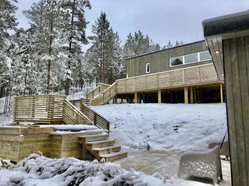 a wooden house with snow on the ground at Tretoppen - Ny moderne hytte, Unike Finnskogen in Torsby