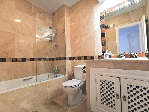 y baño con aseo, bañera y lavamanos. en Nice apartment in a wonderful area, en Villacosta
