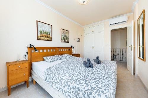 a bedroom with a bed and a dresser and a bed at Garden Sweets Chalet in Orihuela