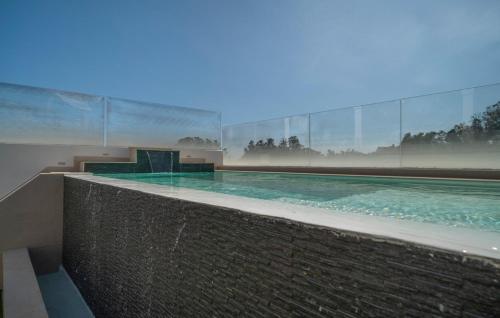 a swimming pool with blue water in a building at Thelifehouse in Marbella