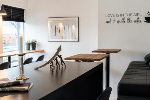 a living room with a table and a couch at Hotel Herning in Herning