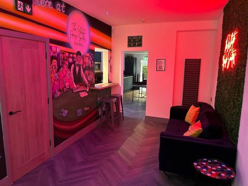 a room with a video game room with a couch at The White House Vegas Suites in Blackpool
