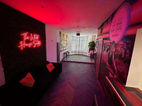 a room with neon signs on the walls at The White House Vegas Suites in Blackpool