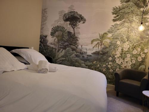 a bedroom with a white bed with a wall mural at Ainay/centre Lyon/un cocon ! in Lyon