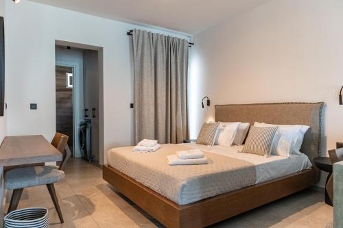 a bedroom with a bed with two towels on it at Chelmis Sea Front Apartments - Oceanis in Argostoli