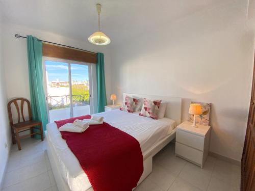 a bedroom with a large bed with a window at Algarve Manta Rota Terrace by Homing in Manta Rota