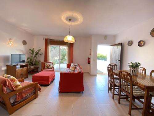 a living room with a table and a dining room at Algarve Manta Rota Terrace by Homing in Manta Rota