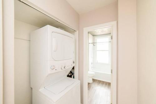 a white laundry room with a washer and dryer at Comfortable and Walkable - Off-Street Parking in Pittsburgh