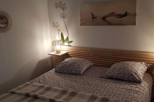 a bedroom with a bed with two pillows on it at Le Patio in Saintes-Maries-de-la-Mer