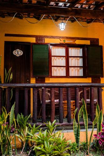 a house with a wooden fence in front of it at Espaço Viverde Penedo in Penedo