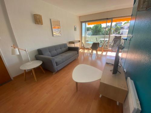 un salon avec un canapé et une table dans l'établissement Charmant T2 avec Terrasse Sud, Accès Plage et Parking Sécurisé à Arcachon - FR-1-374-85, à Arcachon