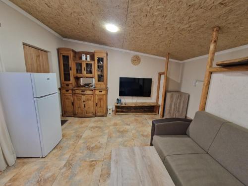 a living room with a couch and a white refrigerator at Mankus Eco Park in Dzoraghpʼyur