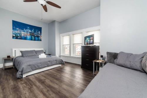 a bedroom with a bed and a couch at Massive Home - GroupStay - Parking & Location in Pittsburgh