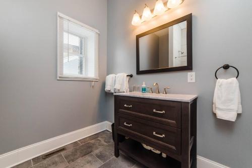 a bathroom with a sink and a mirror at Massive Home - GroupStay - Parking & Location in Pittsburgh