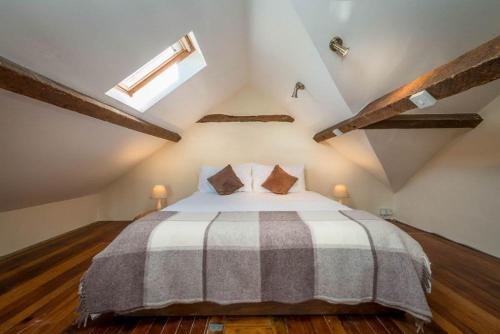 a bedroom with a large bed in the attic at Melin-Byrdir in Dyffryn