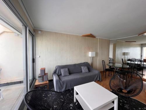 un salon avec un canapé et une table dans l'établissement Appartement 3 pièces face plage avec terrasse et garage - Les Sables d'Olonne - FR-1-197-388, à Les Sables-dʼOlonne