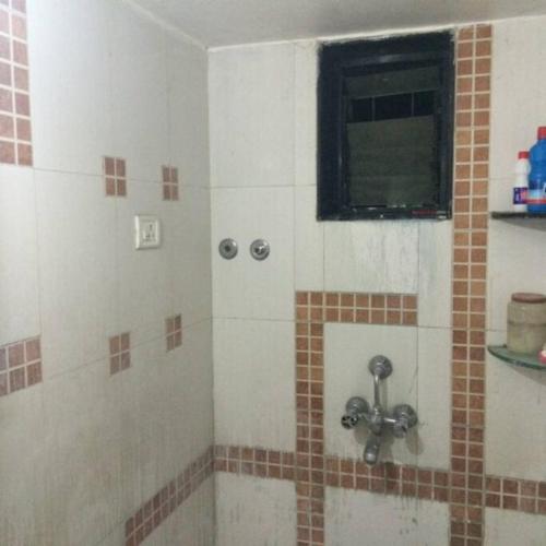 a bathroom with a shower with a window at Luxurious 2BHK bunglow with garden in Solapur