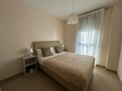 a bedroom with a large bed and a window at Ronda Navarra by Valdesierra in Béjar