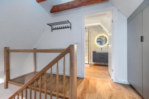 einen Flur mit einer Treppe und ein Badezimmer mit einem Waschbecken in der Unterkunft Apartament Gran in Stettin