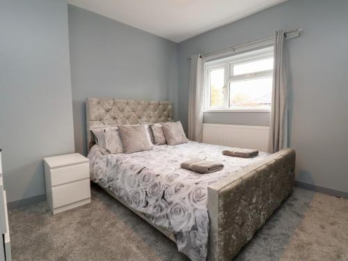 a bedroom with a large bed and a window at Woodside in Wrexham