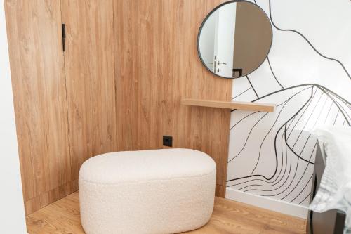 a room with a stool and a mirror at GO Jahorina by Olympic Gardens in Jahorina