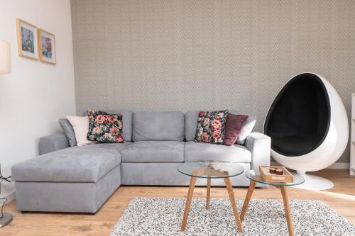 a living room with a gray couch and a table at GO Jahorina by Olympic Gardens in Jahorina