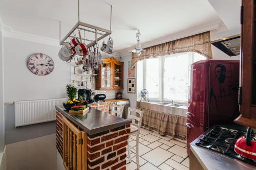 a kitchen with a red refrigerator and a sink at Apartamenty Colobrzeg Sweet Home in Kołobrzeg