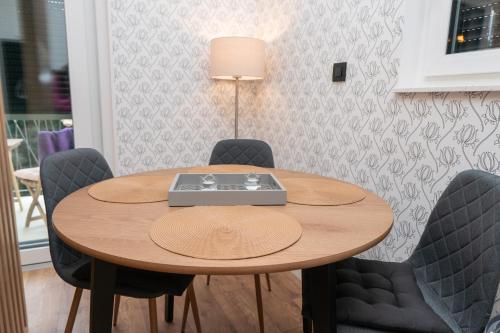 a wooden table with chairs and a laptop on it at GO Jahorina by Olympic Gardens in Jahorina