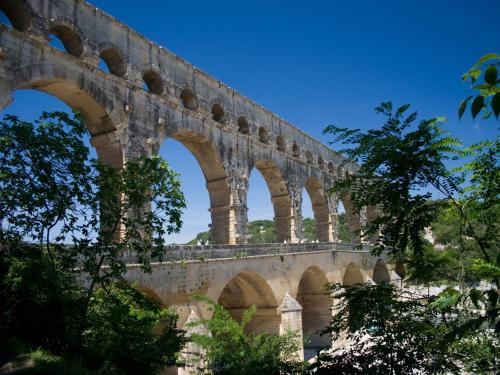 a stone bridge with arches on top of it at Du Côté Des Olivades in Paradou