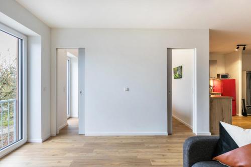 a living room with white walls and a couch at Zum Krähenholz Wohnung 9 in Husby