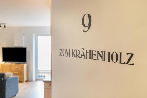 a sign on a wall in a living room at Zum Krähenholz Wohnung 9 in Husby