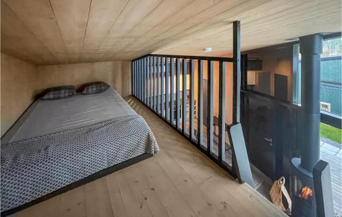 a bed in a tiny house with a balcony at Awesome Home In Grua With House A Panoramic View in Harestua