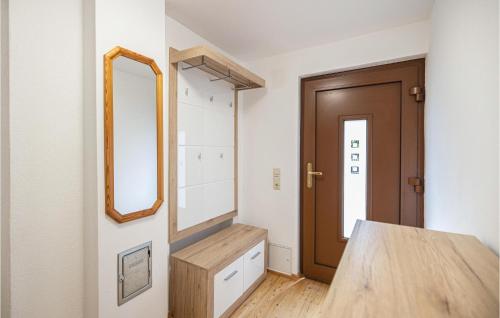 uma sala de vestir com um espelho e uma porta de madeira em Cozy Home With Fireplace em Oberwart