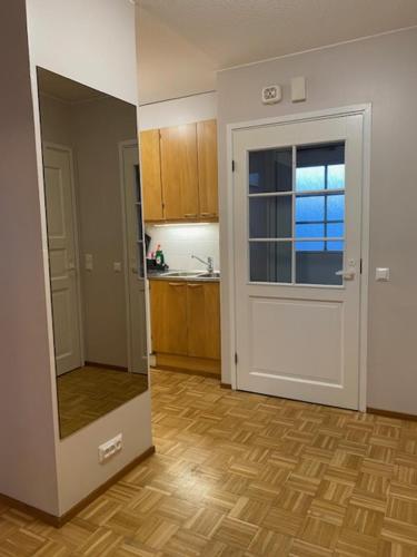 a room with a kitchen with a door and a floor at Apartment Kustaava with sauna in Rovaniemi