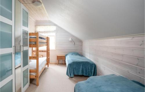 a bedroom with two bunk beds and a ladder at Amazing Home In Vanvik With Kitchen in Sand