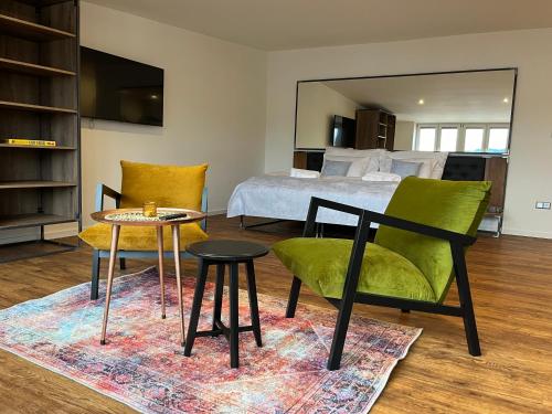 a bedroom with a bed and a table and chairs at Apartmány Malé náměstí, Broumov in Broumov