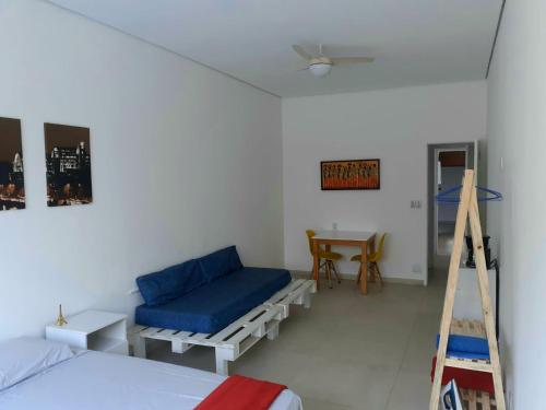 a bedroom with a bed and a ladder and a desk at Suíte Privativa em Casa de Vila in Rio de Janeiro