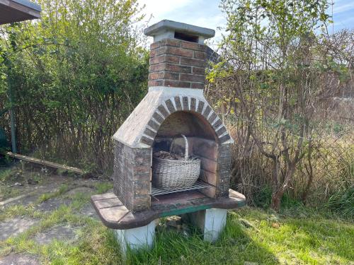a brick oven with a basket inside of it at Finnhütte nah am Strand 