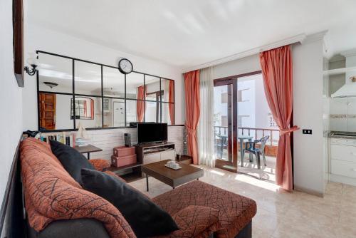 een woonkamer met een bank en een tv bij Apartamento el descanso in Candelaria