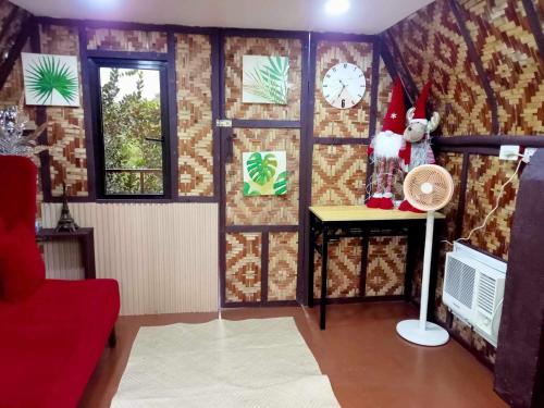 a room with a room with a wall with a clock at LK Farmcation Cabin Ligaya - Lucban, Quezon in Nalunao