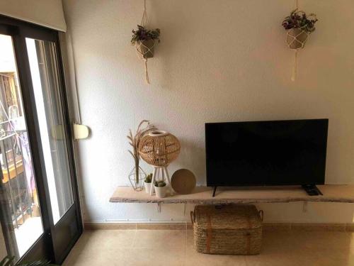 a living room with a flat screen tv on a wall at Casa Vincent, 350 m tot strand, airco in Villajoyosa