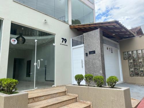 a building with a door and stairs in front at Hotel APART Zuccolotto 101 in Aracruz