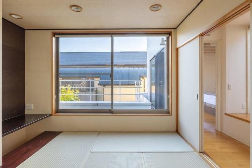 ein leerer Raum mit einem großen Fenster mit Aussicht in der Unterkunft Okusawa Private House in Tokio
