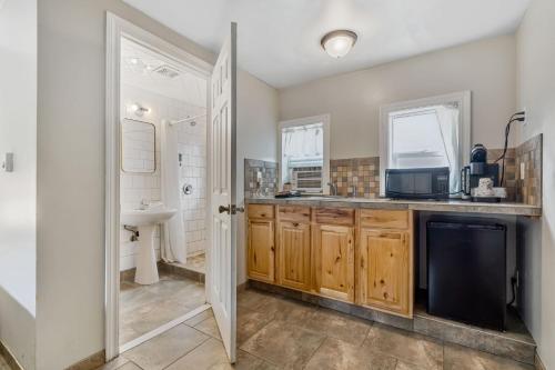 a kitchen with a sink and a microwave at Selkirk Motel in Colville