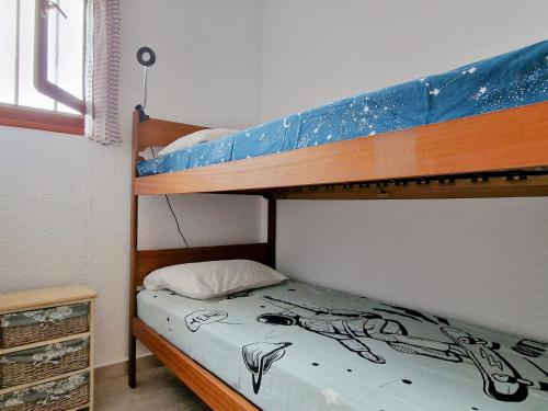 a bedroom with a bunk bed with a depiction of a woman at Studio Banyuls-sur-Mer, 1 pièce, 4 personnes - FR-1-309-277 in Banyuls-sur-Mer