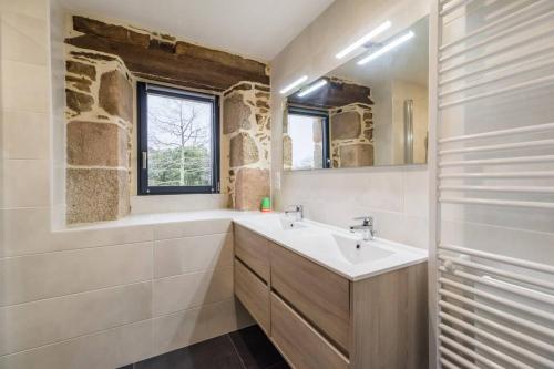 a bathroom with a sink and a mirror at Manoir de Kervegan : Le Logis du Grand Couchant in Lannion